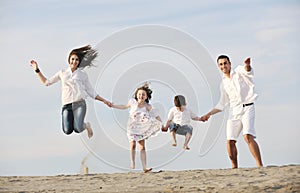 Happy young family have fun on beach