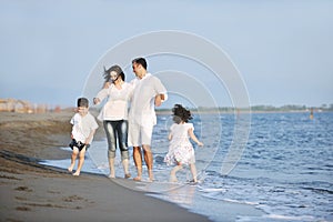 Happy young family have fun on beach