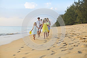 Happy young family have fun on beach run and jump