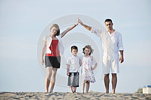 Happy young family have fun on beach at sunset