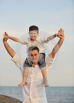 Happy young family have fun on beach at sunset