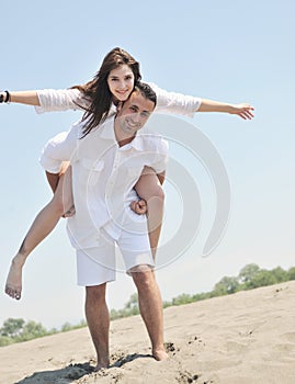 Happy young family have fun on beach at sunset