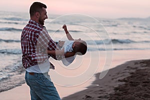 Happy young family have fun and live healthy lifestyle on beach. Selective focus