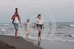 Happy young family have fun and live healthy lifestyle on beach. Selective focus