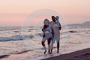 Happy young family have fun and live healthy lifestyle on beach. Selective focus