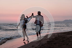 Happy young family have fun and live healthy lifestyle on beach. Selective focus