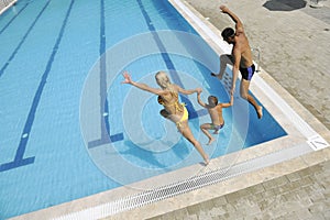 Happy young family have fun on swimming pool