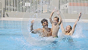 Happy young family have fun on swimming pool