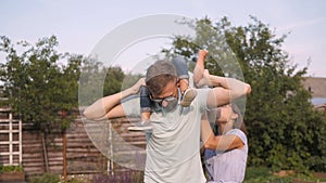 Happy Young Family Having Fun Outdoors. Mom, Dad and Kid Walking, Enjoying Nature Outside.