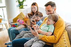 Happy young family having fun times and playing together at home