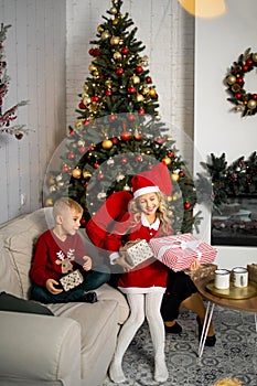 Happy young family with kids having fun celebrating christmas. Christmas time at home.