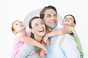 Happy young family looking up together