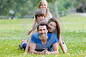 Happy young Family lying on grass