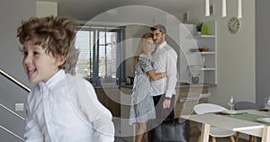 Happy young family in new home at moving day concept, excited children running into big modern own house hallway