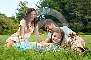 Happy Young Family In Park. Parents And Kids Having Fun, Playing