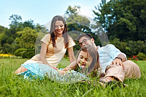 Happy Young Family In Park. Parents And Kids Having Fun, Playing