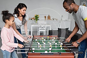 happy young family playing table football together