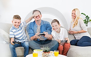 Happy young family playing videogame On TV.