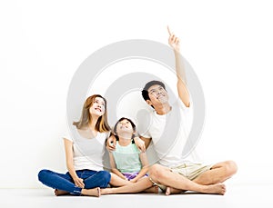Happy Young Family pointing and looking up