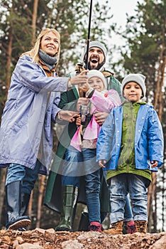 happy young family in raincoats