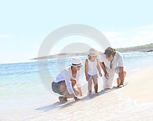 Happy young family spending time on the beach