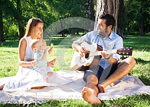 Happy young family spending time outdoor on a summer day