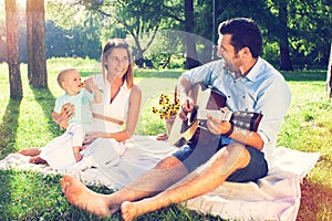 Happy young family spending time outdoor on a summer day