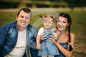 Happy young family spending time outdoor on a summer day