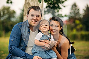 Happy young family spending time outdoor on a summer day