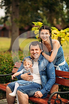 Happy young family spending time outdoor on a summer day