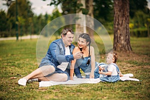 Happy young family spending time outdoor on a summer day