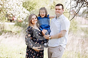 Happy young family spending time outdoor on a summer day