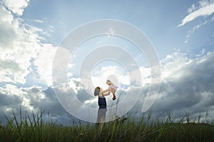 Happy young family spending time outdoor on a summer day - Vibrant color effect