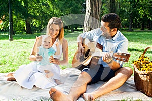 Happy young family spending time outdoor on a summer daycouple
