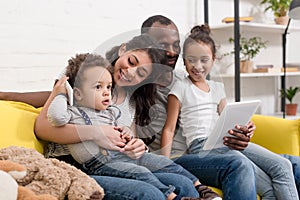 happy young family spending time together with devices