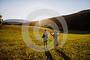 Happy young family spending time together outside in green nature.