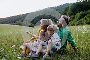 Happy young family spending time together outside in green nature.