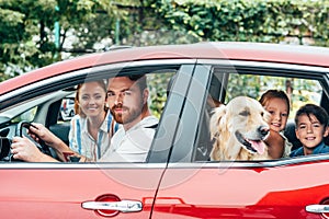 happy young family travelling by car