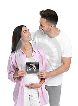 Happy young family with ultrasound picture on white