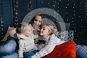 Happy young family in warm and cozy living room on winter day
