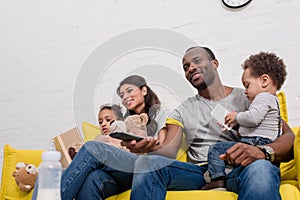 happy young family watching tv together