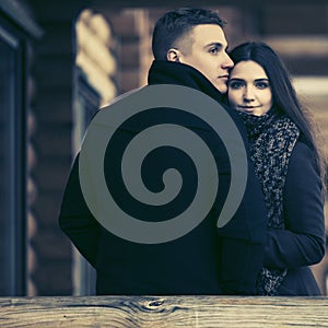 Happy young fashion couple on the porch of cottage