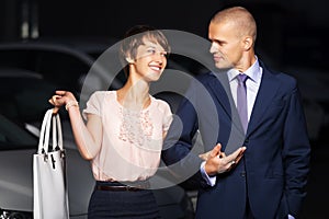 Happy young fashion couple walking in night city street