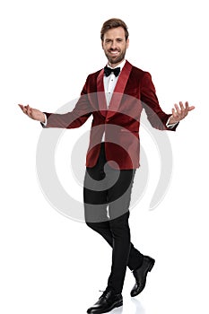 Happy young fashion man wearing red velvet tuxedo