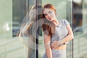 Happy young fashion woman in gray crop top and skirt suit photo