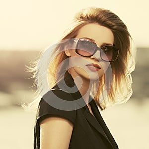 Happy young fashion woman in sunglasses outdoor