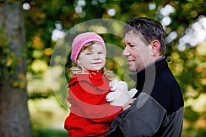 Happy young father having fun cute toddler daughter, family portrait together. Middle-aged Man with beautiful baby girl