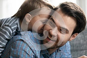 Happy young father and little son playing at home