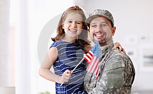 Happy young father in military uniform reunited with cute little daughter at home