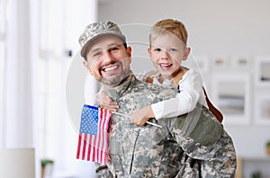 Happy young father in military uniform reunited with cute little son at home